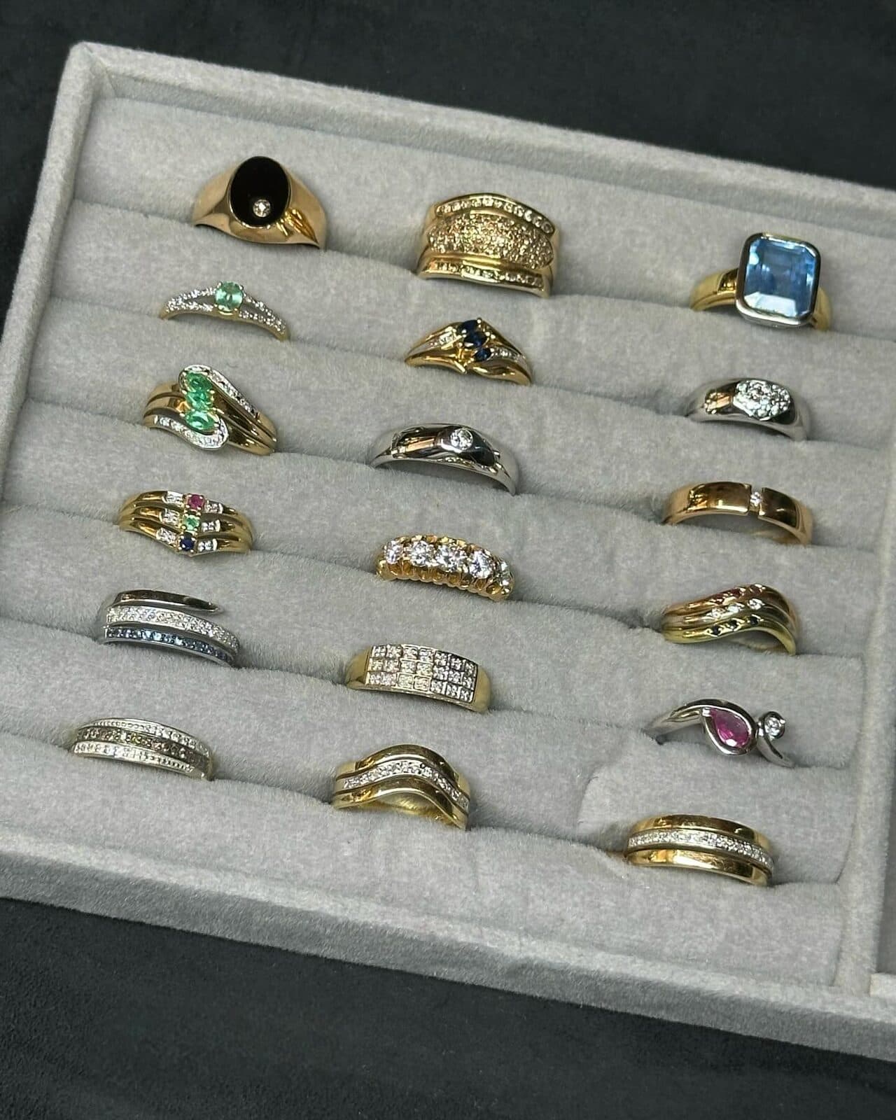 A tray of rings in rows.