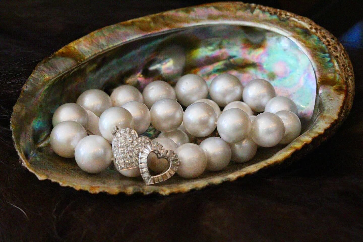 Pearls and two heart pendants in an iridescent shell.